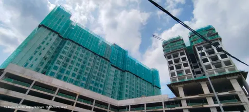 The two 18-storey towers of IX SURIA Residences rising under construction, May 2026.